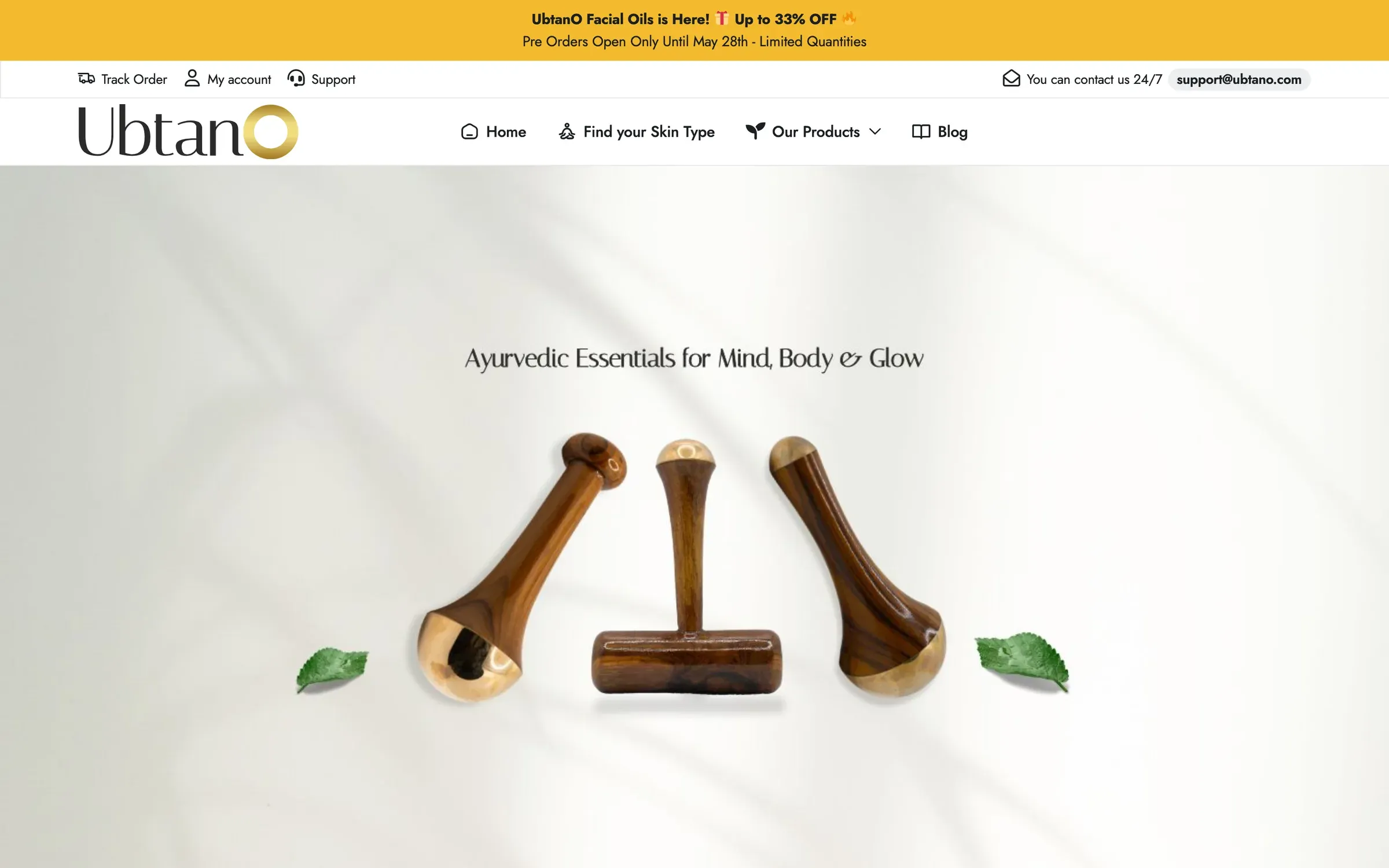 Ubtano home page: three wooden Ayurvedic massage tools with leaves under the line "Ayurvedic Essentials for Mind, Body & Glow"