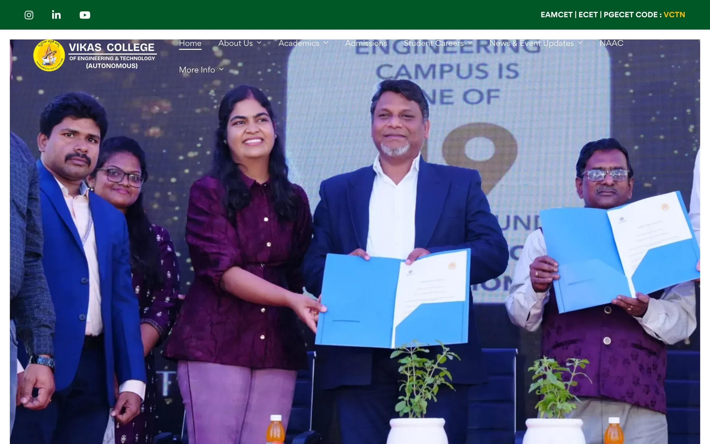 Vikas College of Engineering & Technology home page: the college logo and menu above a photo of faculty at a memorandum-signing ceremony